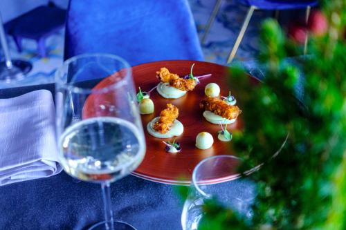 a plate of deviled eggs and a glass of wine at Villa Aragonese Rooms in Monte di Procida