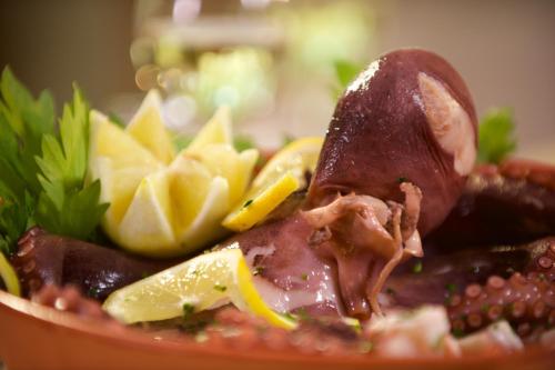 a bowl of food with meat and potato chips at Hotel Portonuovo in Vieste