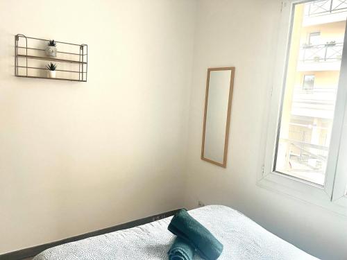 a bedroom with a bed with a mirror and a window at Studio -SweetHome - Paris-Disney - 3 Min Gare in Bussy-Saint-Georges