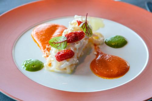 a plate of food on a pink plate at Villa Aragonese Rooms in Monte di Procida