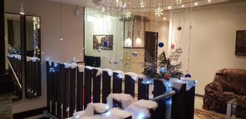 a room with a christmas tree and a fence with lights at ASA Hotel in Yerevan
