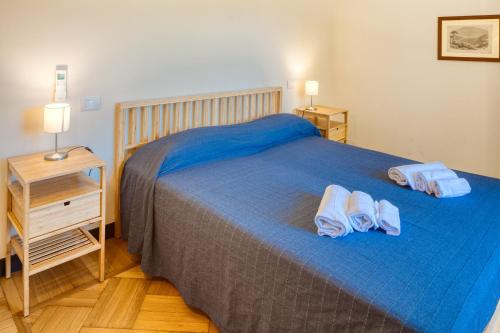 a bedroom with a bed with two towels on it at PORTOVECCHIO Plus in Levanto