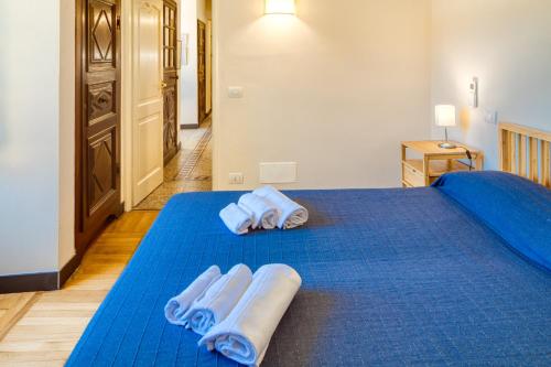 a bedroom with a blue bed with towels on it at PORTOVECCHIO Plus in Levanto