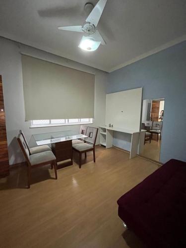 里約熱內盧的住宿－Apartamento em Botafogo，一间带椅子和桌子的房间以及白色的板子