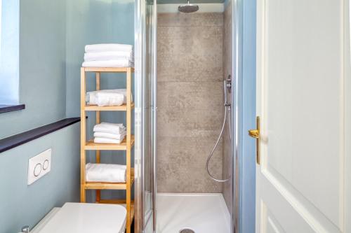 a bathroom with a shower and a toilet and towels at PORTOVECCHIO Plus in Levanto