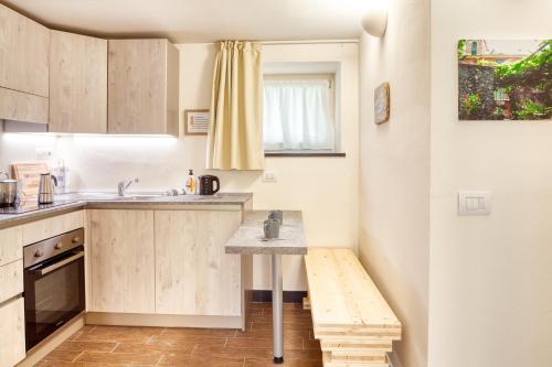 a small kitchen with a sink and a table at PORTOVECCHIO Plus in Levanto