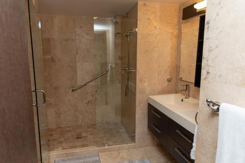 a bathroom with a shower and a sink at A Star Oasis Condo in Palm-Eagle Beach