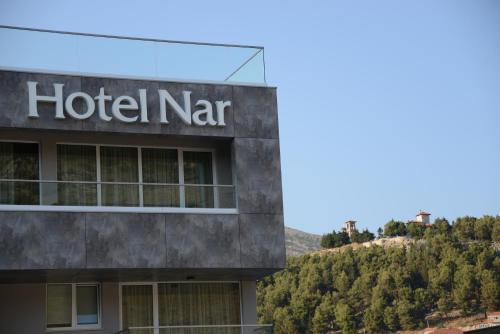 a hotel sign on the side of a building at Hotel Nar in Trebinje