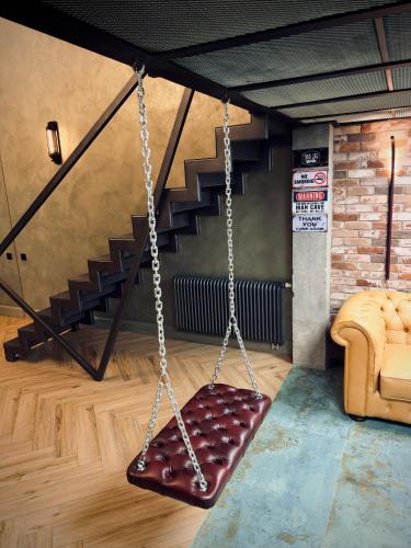 a swing in a room with a staircase at ALL - Amberstone Lux Loft in Klaipėda