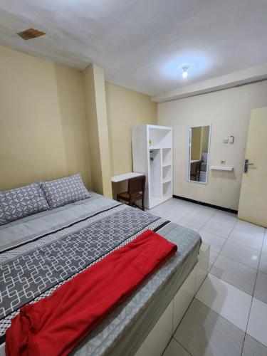 a bedroom with a large bed and a mirror at Penginapan PIP Semarang in Jomblang