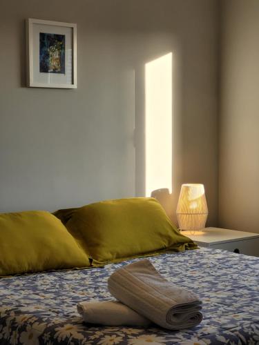a bedroom with a bed with yellow sheets and a window at Céu Playa Unión in Playa Unión