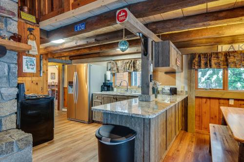 a kitchen with a large island in a cabin at Pittsburg Lake House with Magalloway Mountain Views! in Pittsburg