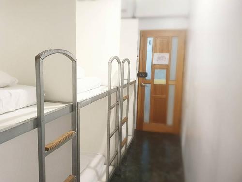 a room with three bunk beds and a door at COZY Home in Taipei