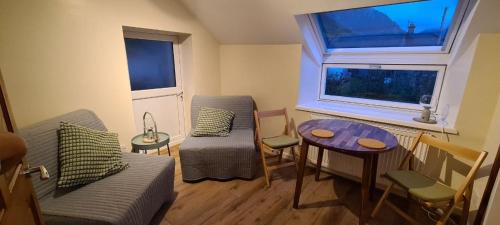 a living room with a couch and a table at Snowdonia Mountain Lodge in Bethesda