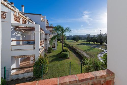 a view from the balcony of a house with a golf course at Mijas Golf in Santa Fe de los Boliches