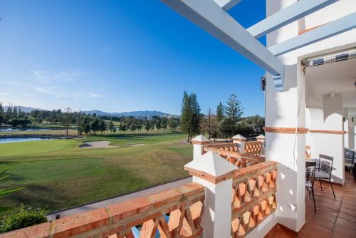 a view of the golf course from the balcony of a house at Mijas Golf in Santa Fe de los Boliches