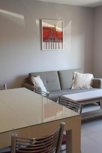 a living room with a glass table and a couch at Céu Playa Unión in Playa Unión