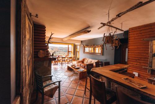 a kitchen and living room with a table and chairs at HOTEL NOMADES PATAGONIA in Coihaique