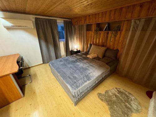 a bedroom with a bed and a couch at Nice house with pool, massage chair and sauna in Porsgrunn