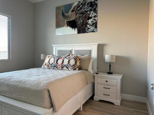 a bedroom with a bed and a painting on the wall at Desert Gem - Mesquite in Mesquite