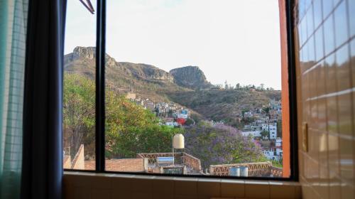 a view of a city from a window at Posada La Mora - Hospedaje Panoramico in Guanajuato