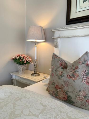a bedroom with a bed with a pillow and a lamp at KarMichael Farm in Himeville
