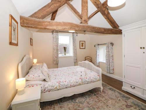 a bedroom with a bed and a window at Dale View Cottage in Bakewell