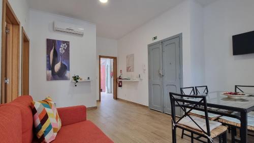 a living room with a red couch and a table at Lightoasis Oeiras 3 in Oeiras