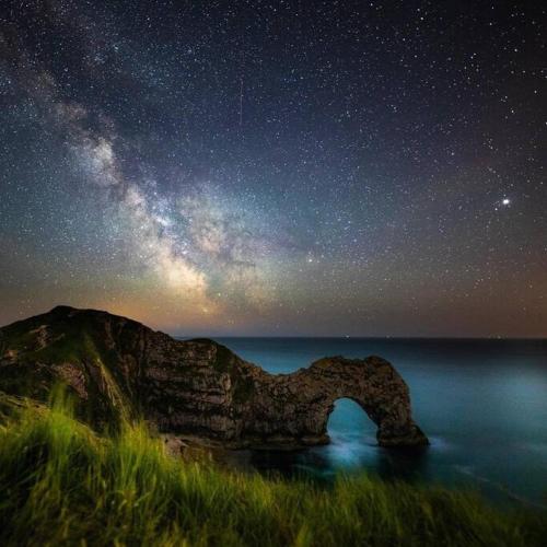 a starry night with a stone arch in the water at Superb Sandbanks Apartment near Beach and Bars with Free Parking in Poole
