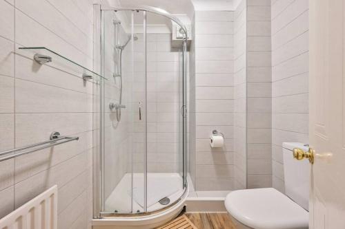 a bathroom with a shower and a toilet at Superb Sandbanks Apartment near Beach and Bars with Free Parking in Poole