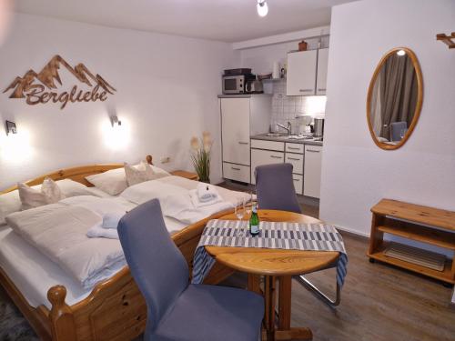 a bedroom with a bed and a table and chairs at Appartement Haus Sonnenheim in Zell am See