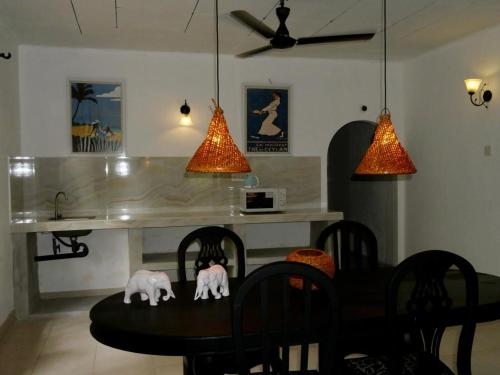 a dining room with a table with two elephants on it at Sri Villa Polwatta in Weligama