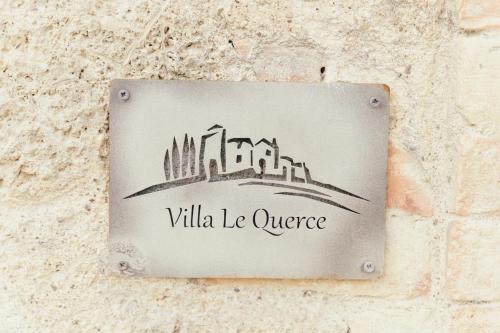 a sign on a stone wall with the words villilla le supreme at Villa Le Querce - San Galgano in Chiusdino