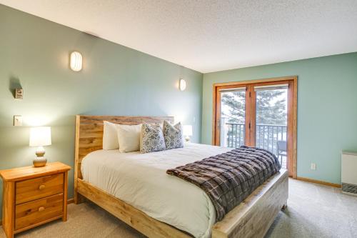 a bedroom with a large bed and a window at Lakefront Tofte Townhome with Deck and Views! in Tofte