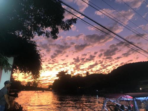 a view of a sunset from a boat in the water at Apartment Ilha da Gigóia in Rio de Janeiro