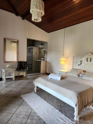 a bedroom with a large bed in a room at Pousada Almar in Pipa