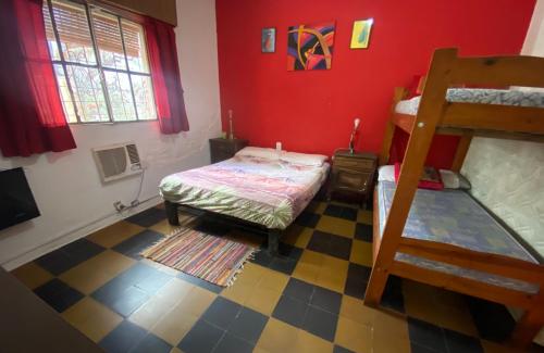 ein Schlafzimmer mit einem Bett und einem Etagenbett in der Unterkunft Casa a una cuadra de costanera Gualeguaychu Hasta 8 personas in Gualeguaychú