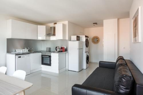 a living room with a couch and a kitchen at Le blanc mesnil bat A 2G in Le Blanc-Mesnil