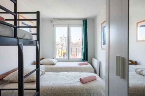a bedroom with two bunk beds and a window at Le blanc mesnil bat A 2G in Le Blanc-Mesnil