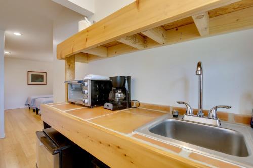 a kitchen with a sink and a microwave at Tranquil Rancho Viego Studio, 29 Mi to Beach in Los Fresnos