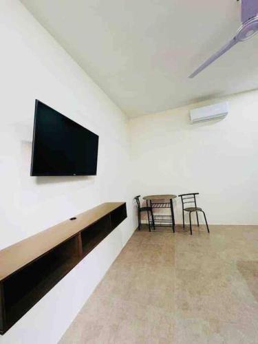 ein Wohnzimmer mit einem Flachbild-TV an der Wand in der Unterkunft Habitación para dos personas in Santa Cruz Huatulco