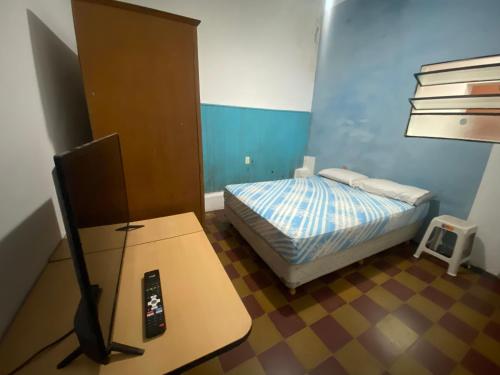 Kleines Zimmer mit einem Bett und einem TV. in der Unterkunft Depto a una cuadra de costanera Gualeguaychú hta 4 personas in Gualeguaychú