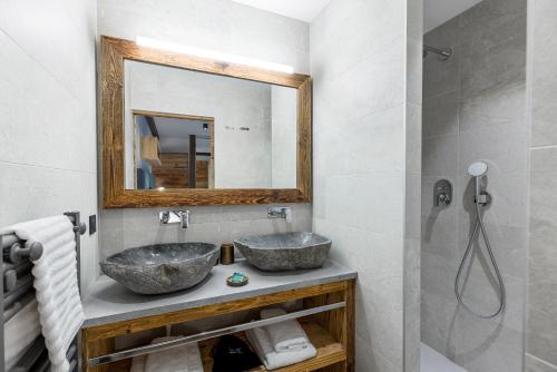 łazienka z 2 umywalkami i lustrem w obiekcie Appartement Thom's - LES GETS, en plein centre et au pied des pistes w mieście Les Gets