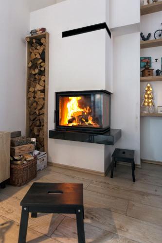 a fireplace in a living room with a fire at Casa Valley Paradiso - Jahorina in Jahorina