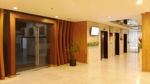 a hallway of an office building with a plant at The SPLENDOR comfortable living by Awsom Phil in Manila