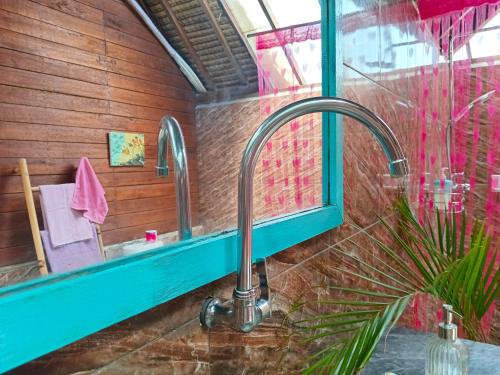 a bathroom with a sink and a mirror at UTOPIA BUNGALOWS in Gili Air