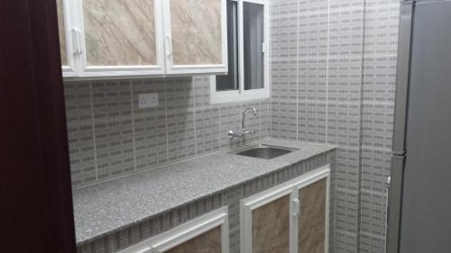 A kitchen or kitchenette at Golden Seasons Furnished Apartment