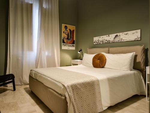a bedroom with a large white bed with a pillow on it at Alloro&Gelsomino in Marsala