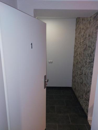a room with a white door and a tile floor at Ferienwohnung I Sarrebriese in Bottmersdorf