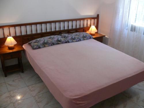 a bedroom with a bed with two lamps on two tables at Casa d'Or in L'Estartit